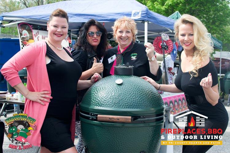 Big Green Egg grill with ladies around it