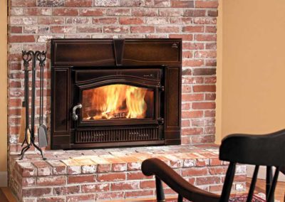 red brick fireplace with brown insert