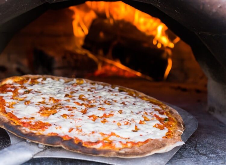 Are wood-fired pizza ovens worth it and what are the benefits?